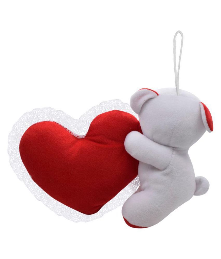 white teddy bear holding a heart